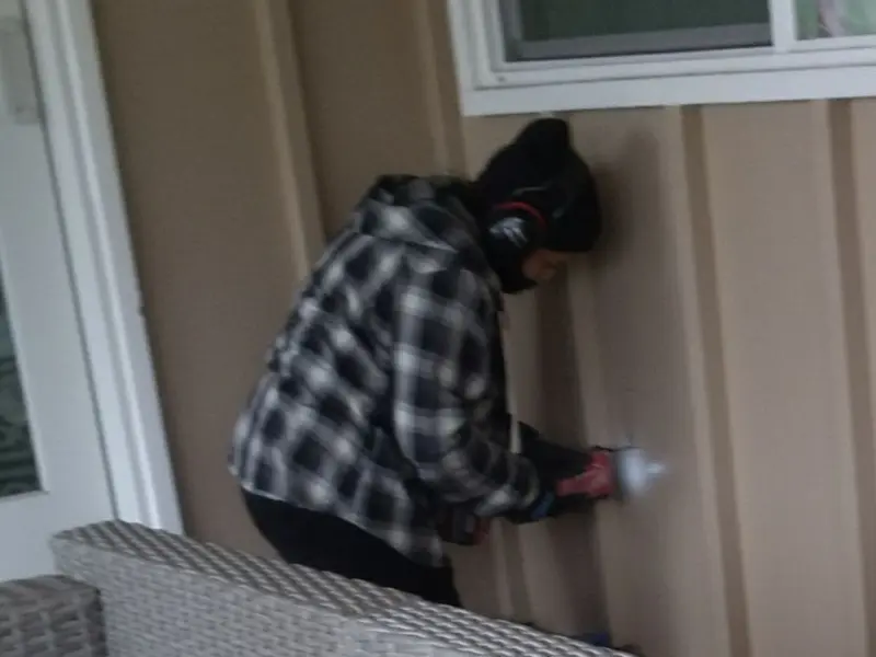 Professional electrician installing an exterior outlet in Nowthen